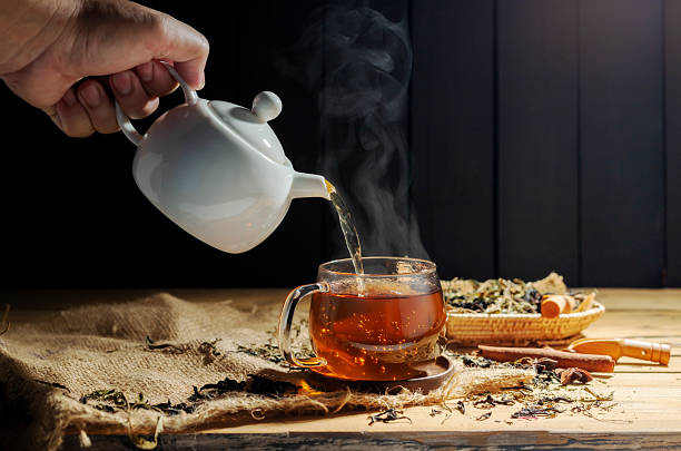 Assorted dried herbal tea ingredients in bowls