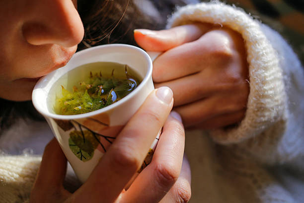 Dried chamomile flowers beside a teacup